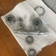 There is the spindle in the middle, the caged bearings on the bottom, the adjustable cup is on the left, the fixed cup is in the center above the spindle, and the lock ring for the adjustable cup is on the top right. The little silver discs in the center are dust caps for the cranks.